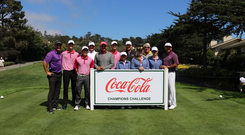 Crowd standing around Coca Cola sign