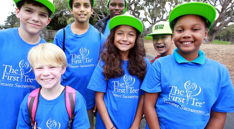 Smiling kids in The First Tee Sacremento t-shirts