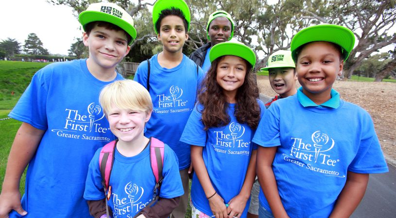 Smiling kids in The First Tee Sacremento t-shirts