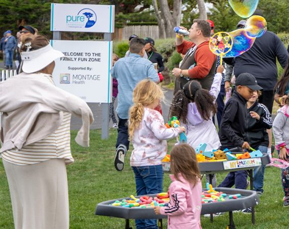 Children playing with bubbles and building blocks in the Family Fun Zone at the tournament