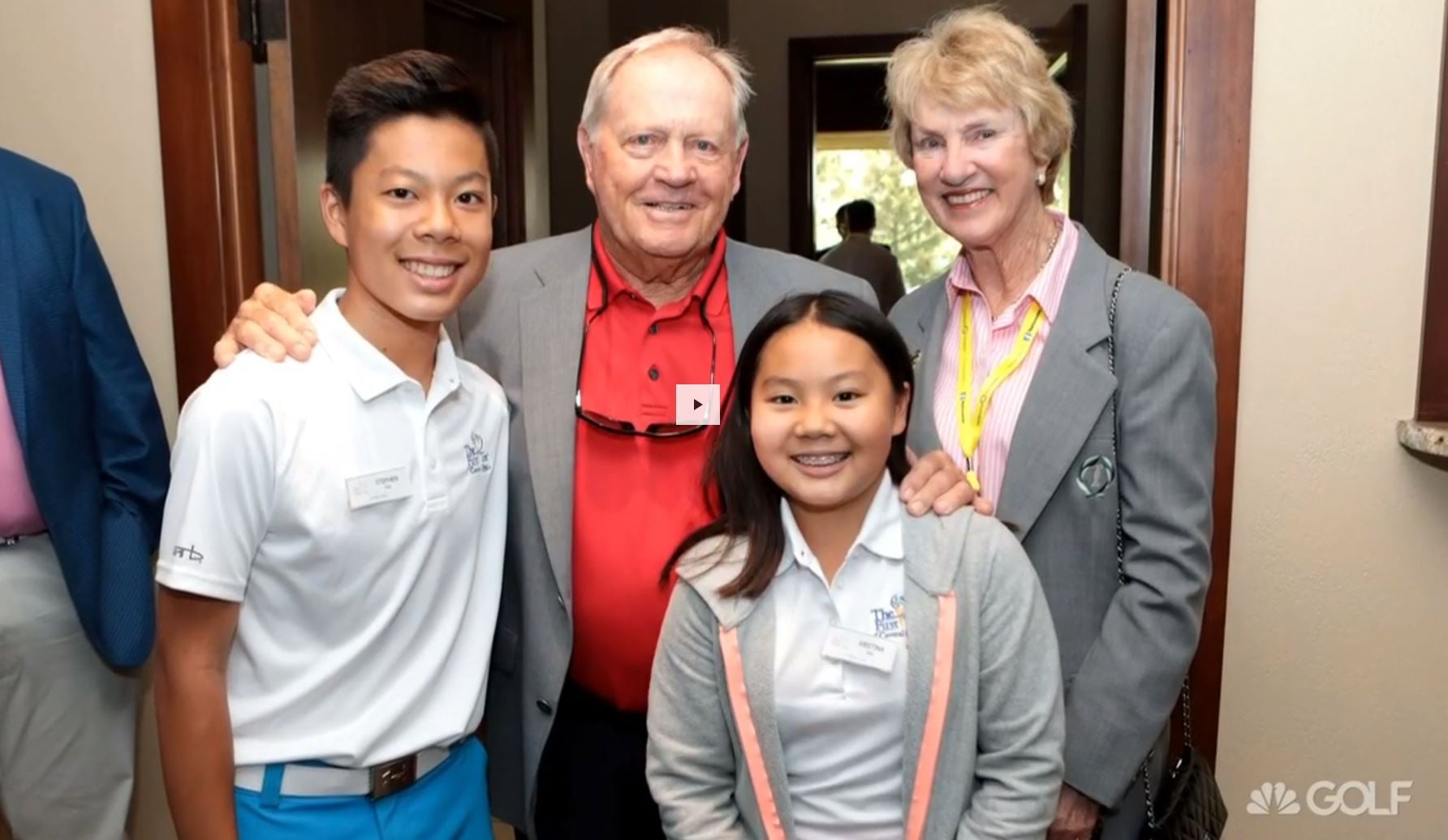Jack Nicklaus and his wife Barbara pose with two young First Tee participants indoors