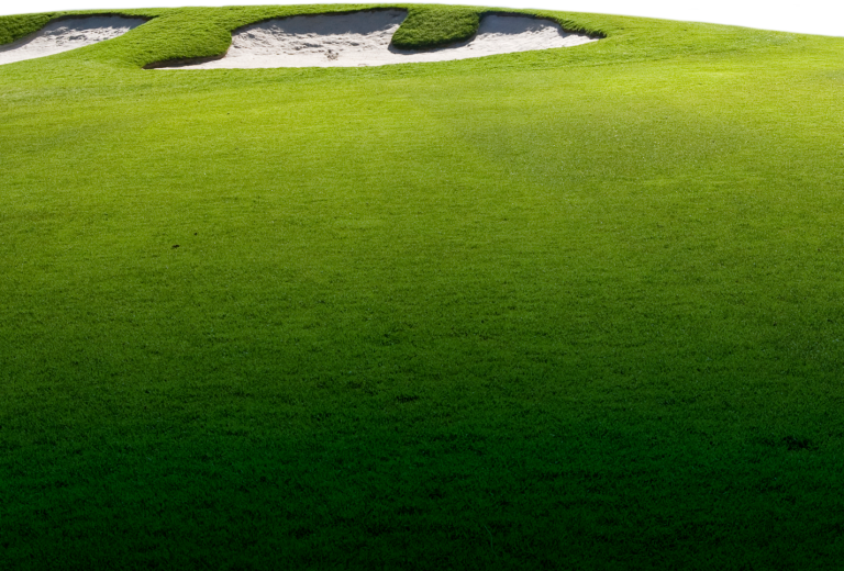 Close-up of a vibrant green fairway leading up to two large, white sand bunkers
